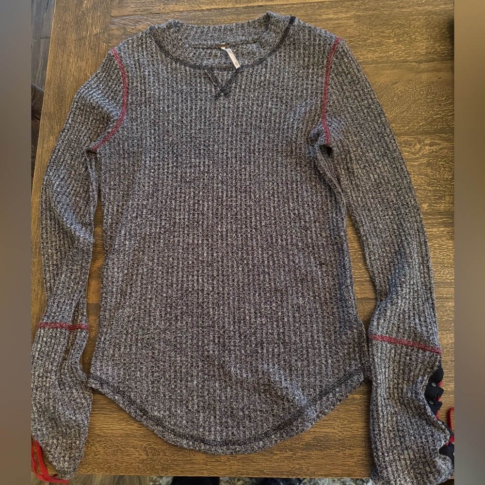 Free People long sleeve ribbed top with laced up red detail on the sleeves.